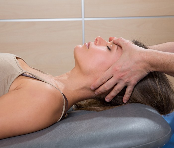Woman relaxing while undergoing cranial osteopathy in Orlando