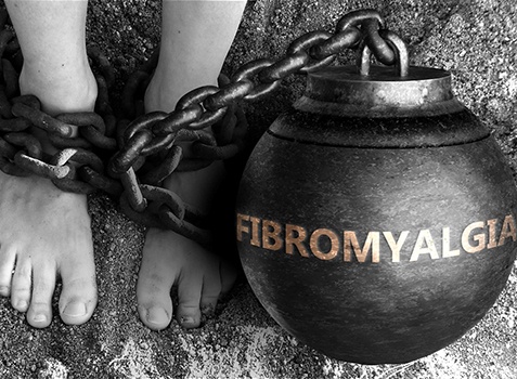 Fibromyalgia illustrated as ball and chain around person’s feet