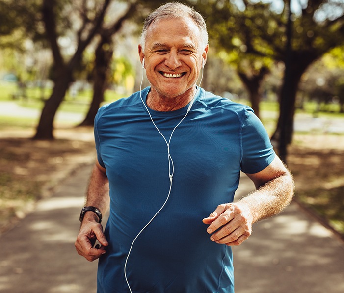 Older man jogging after receiving wellness functional medicine
