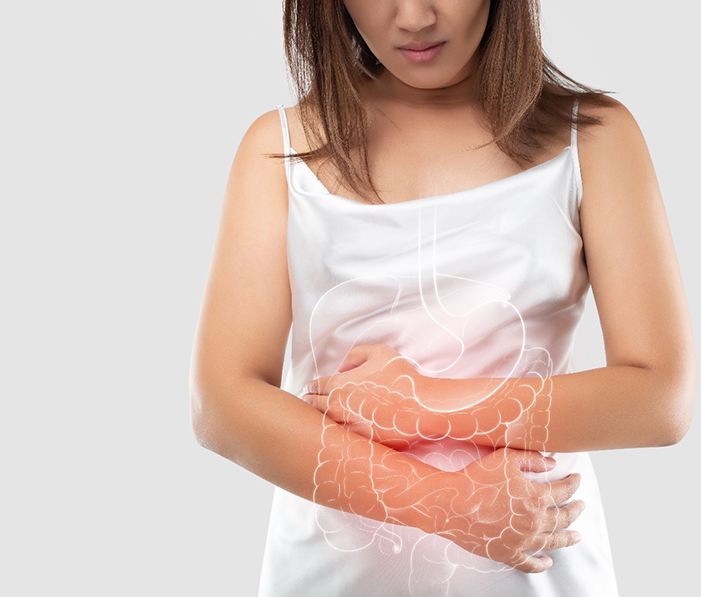 Woman holding her stomach, concerned about leaky gut in St. Cloud