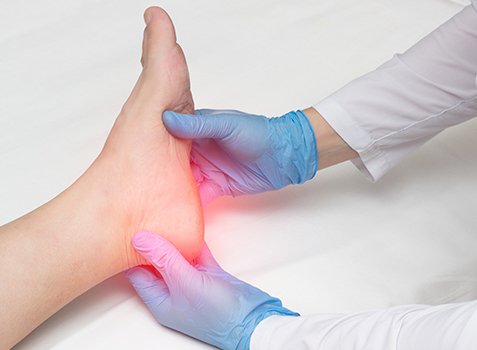 Osteopathic physician examining patient's foot