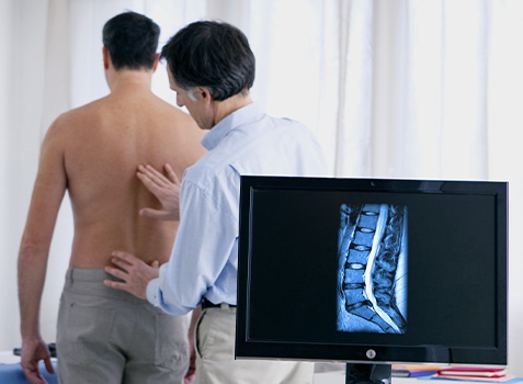Physician examining patient using diagnostic musculoskeletal ultrasound