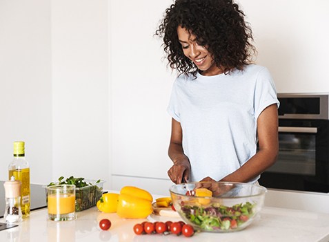 Happy woman preparing nutritious meal after nutritional testing