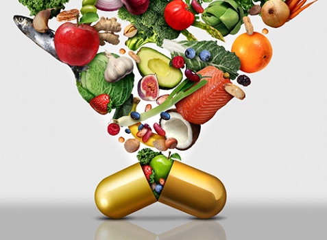 Nutritious foods being packed into gold-colored supplement pill
