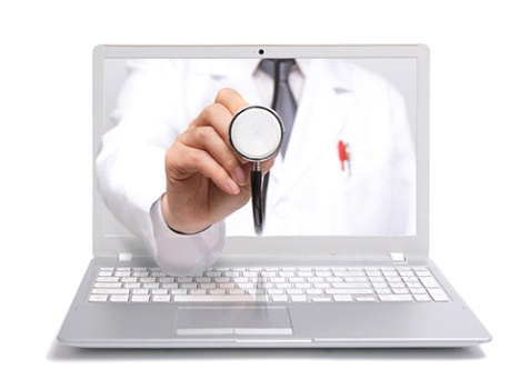 Telemedicine concept — doctor reaching through computer with stethoscope